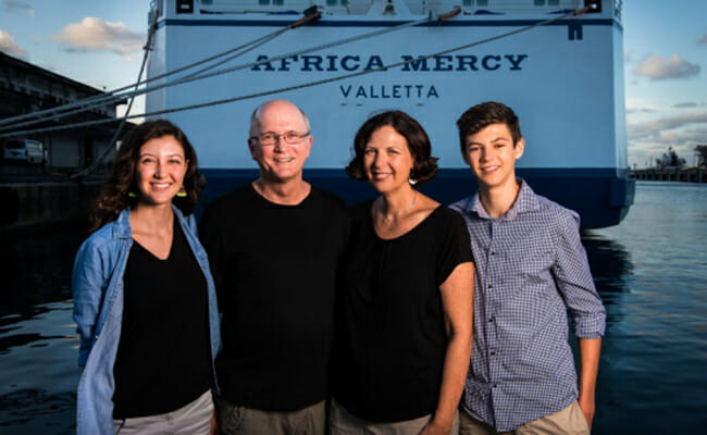 Carys, Gary, Susan and Wesley Parker in front of the Africa Mercy hospital ship. /Courtesy Mercy Ships