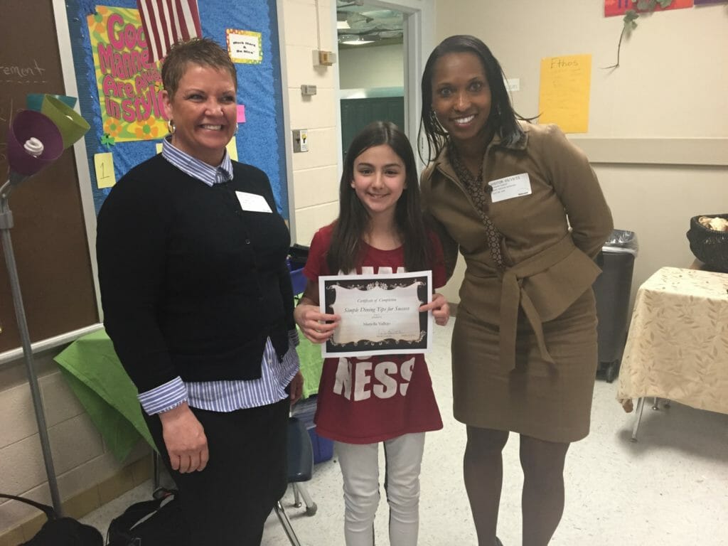 Adrienne Somerville (right) at Dining Like Divas event. Carolyn E. Parker Foundation teaches young girls fine dining, protocol and etiquette./ Courtesy Adrienne Somerville