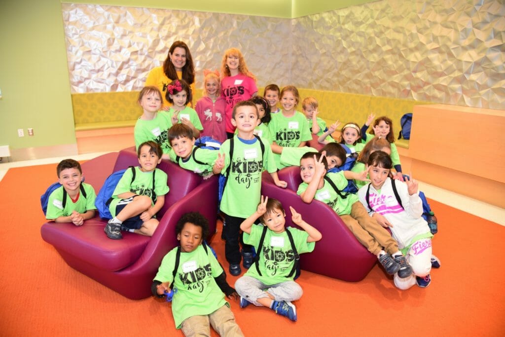 Lori Morton (upper left) pictured with young scientists at Regeneron Kids Day. STEM Fest: Lori Morton with a young inventor at Chappaqua STEM Fest./Courtesy Lori Morton