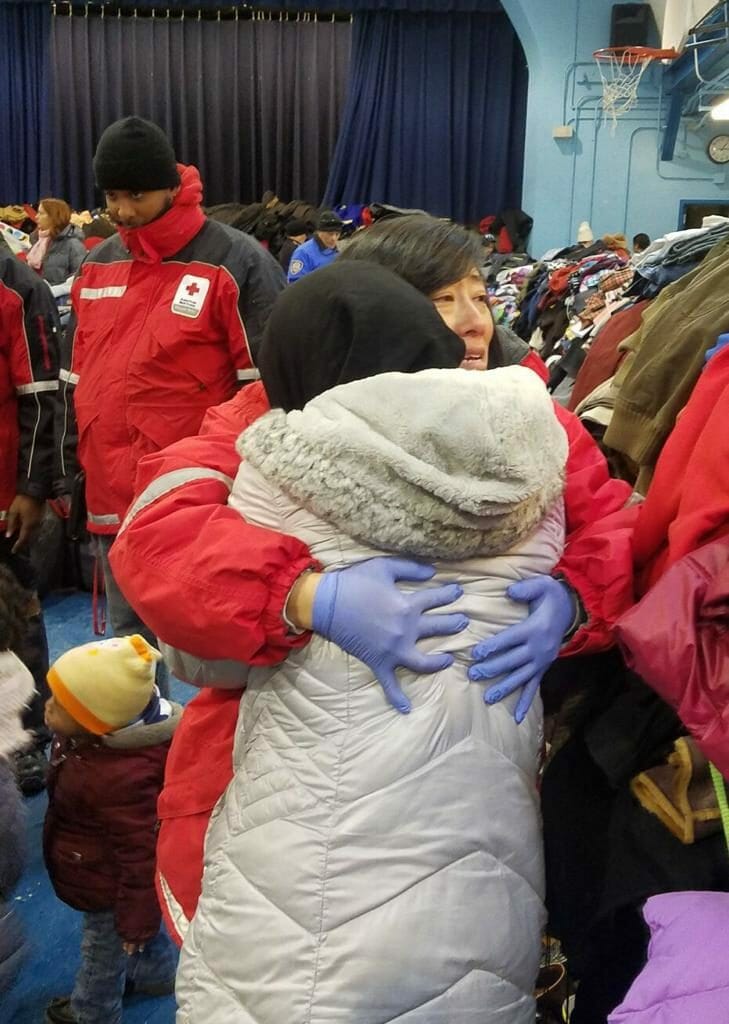 Vivian Moy pictured consoling a woman who lost everything in the historic Bronx, New York fire that killed 12 in all in 2017./ Courtesy Vivan Moy