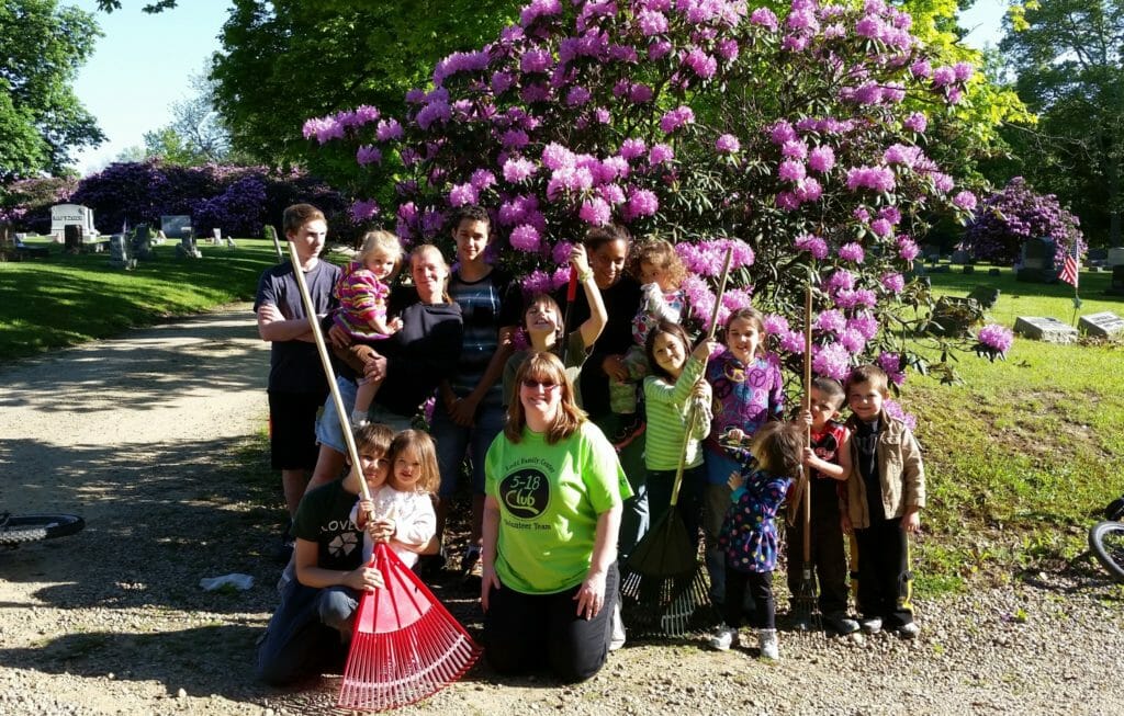 Rebecca Rak (pictured center, green shirt) with Lodi Family Center youths who volunteered alongside their families for spring clean-up at the cemetery in preparation for their Memorial Day ceremony./Courtesy Rebecca Rak