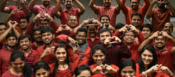 A group of people holding up hearts with their hands.