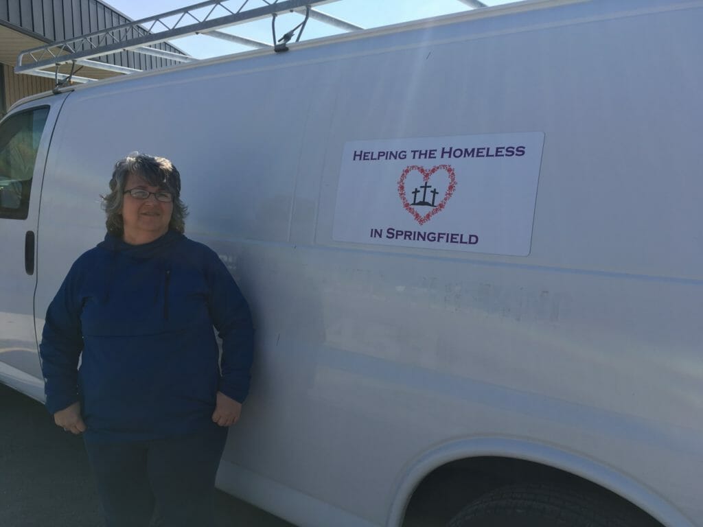 Julie Becker with the van she uses to collect and distribute donations to the homeless/Courtesy Julie Becker