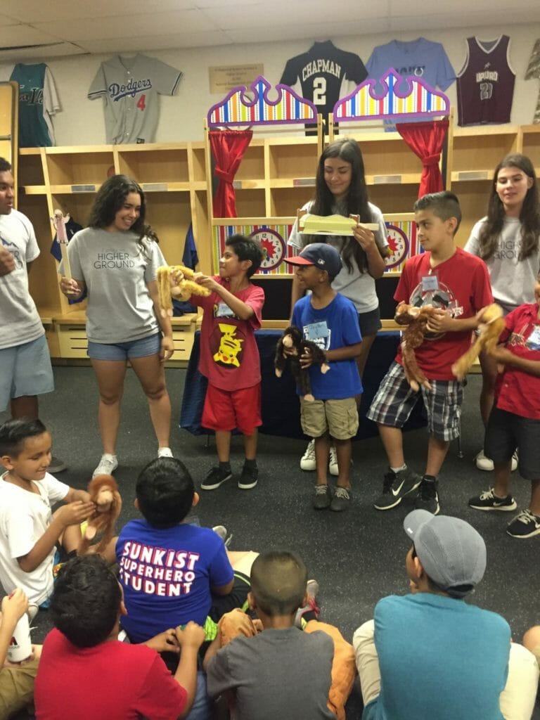 Isabella Tejeda’s program engages students, pictured here reading Five Little Monkeys Jumping on a Bed./Courtesy Isabella Tejeda