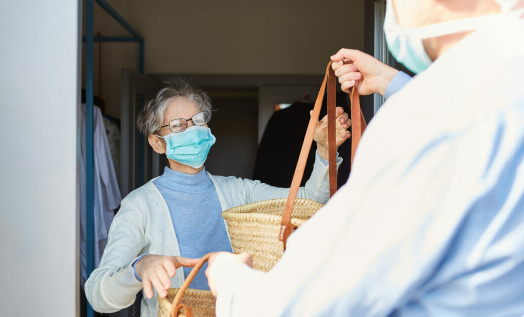 civic engagement; volunteer delivers food to senior