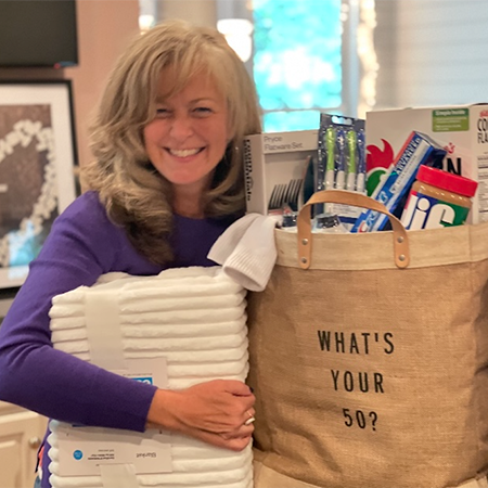 Daily Point of Light Award Honoree Kristen Weinberg poses with examples of items that can be donated as part of the What’s Your 50? movement she started.