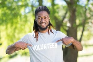 Volunteer smiling at the camera