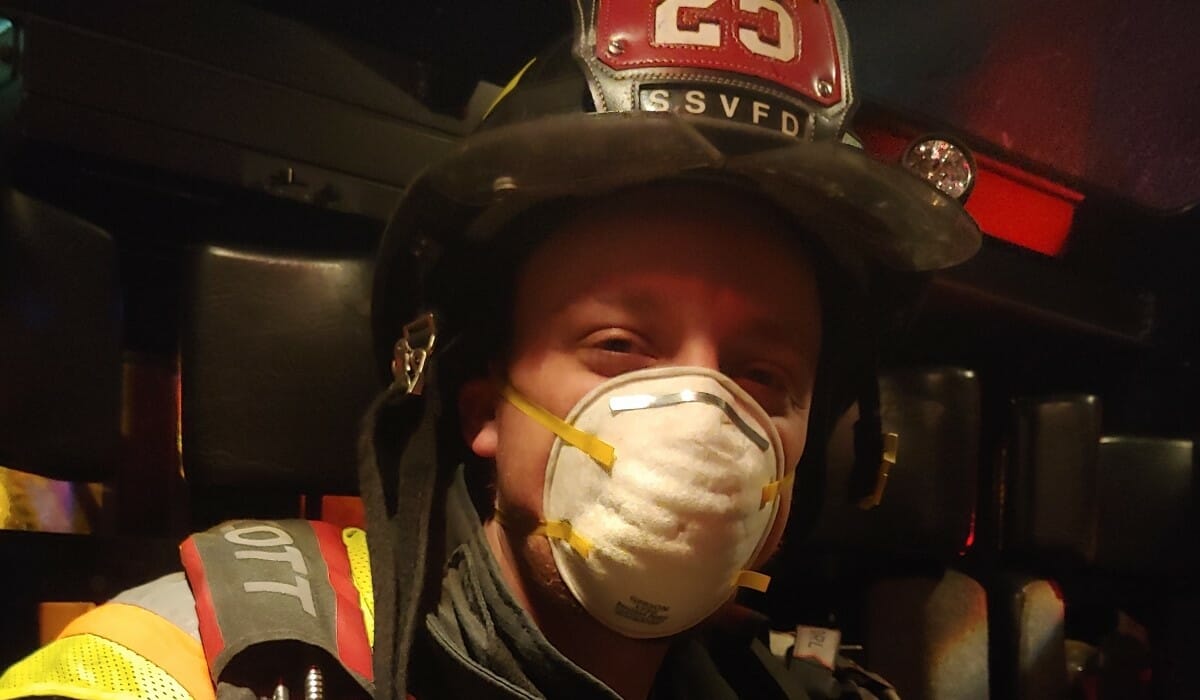 Smiling man dressed in firefighting gear