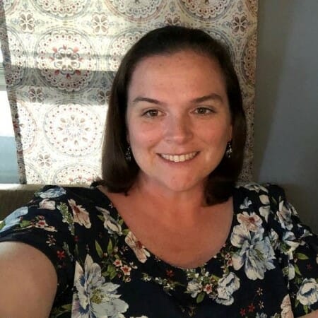 Headshot of a woman in a floral top