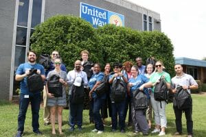 A group of volunteers standing in front of United Way.
