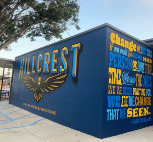 A blue and yellow mural that reads, "Hillcrest".