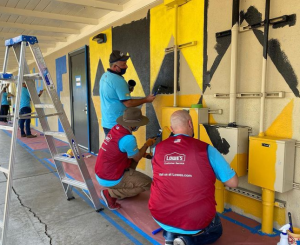 A group of volunteers painting. 