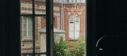 Interior of home looking out toward an antique brick home across the street