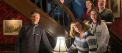 Group of people posing on a staircase.