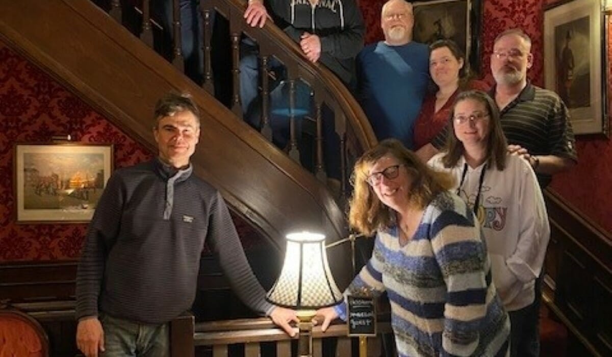 Group of people posing on a staircase.