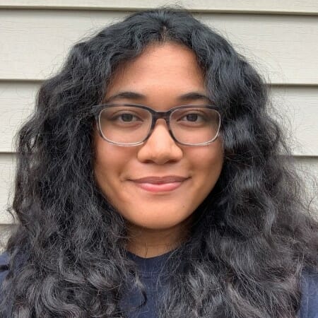 Headshot of a girl with long black hair and glasses.