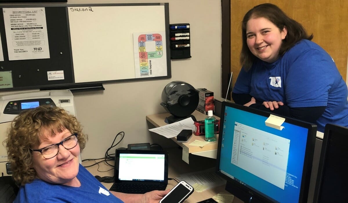 Two women smiling in an office.