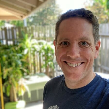 Headshot selfie of a man in a blue t-shirt.