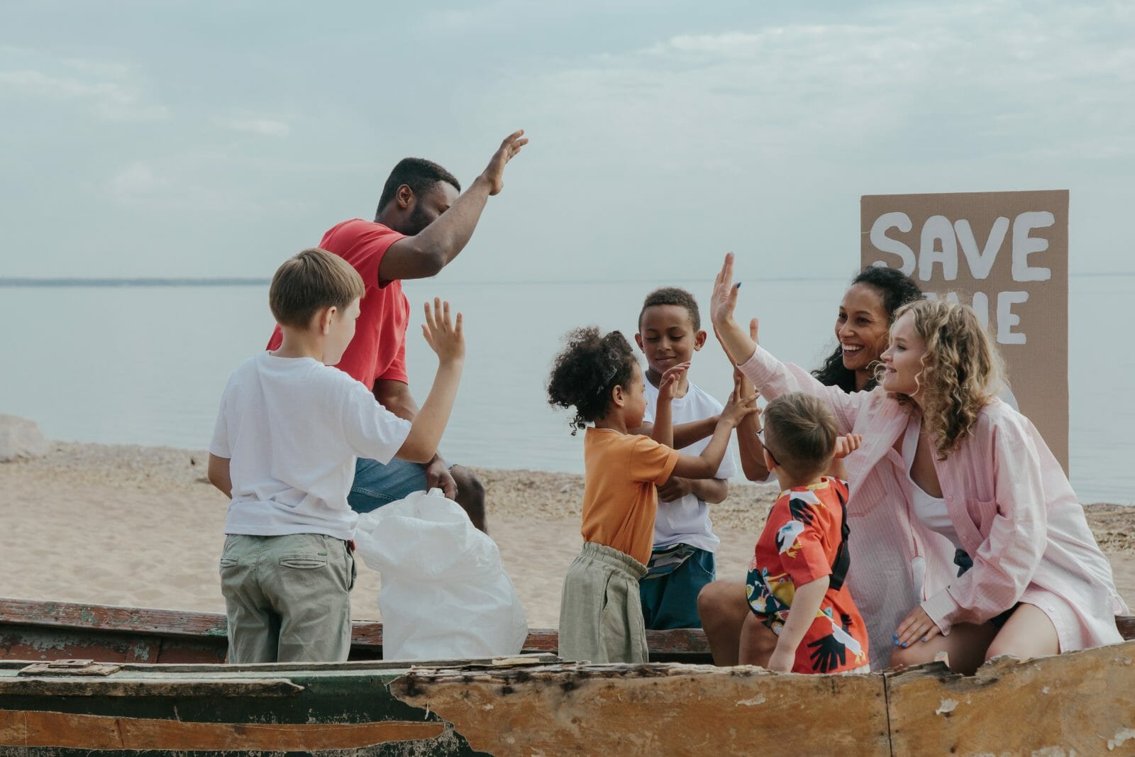 image of families high fiving on the beach